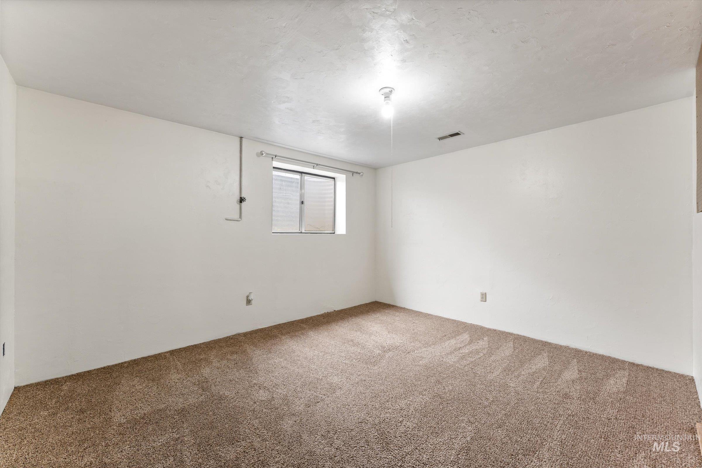 Unfurnished room featuring light colored carpet