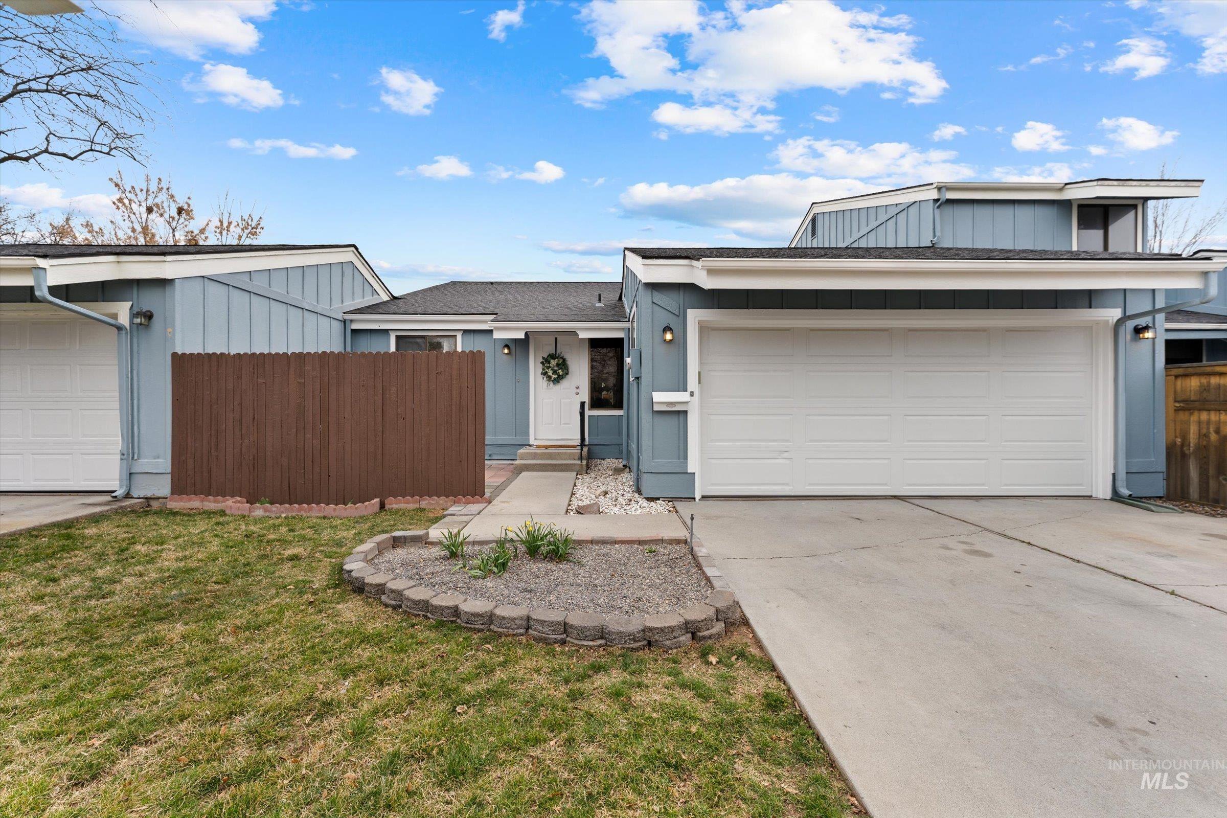 View of front of home featuring a garage, driveway, and board and batten siding