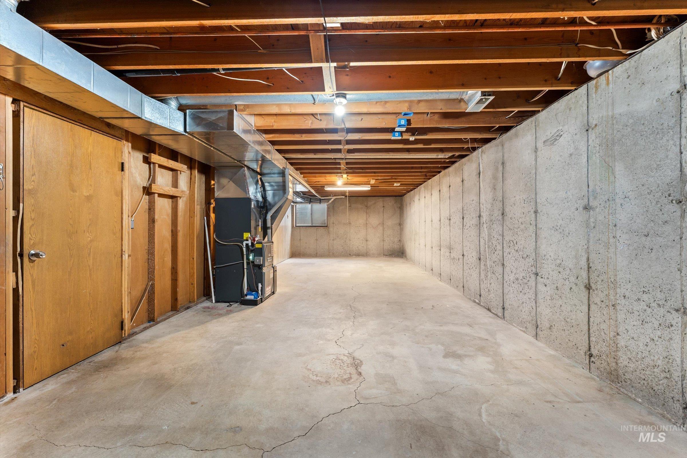 Unfinished below grade area with heating unit