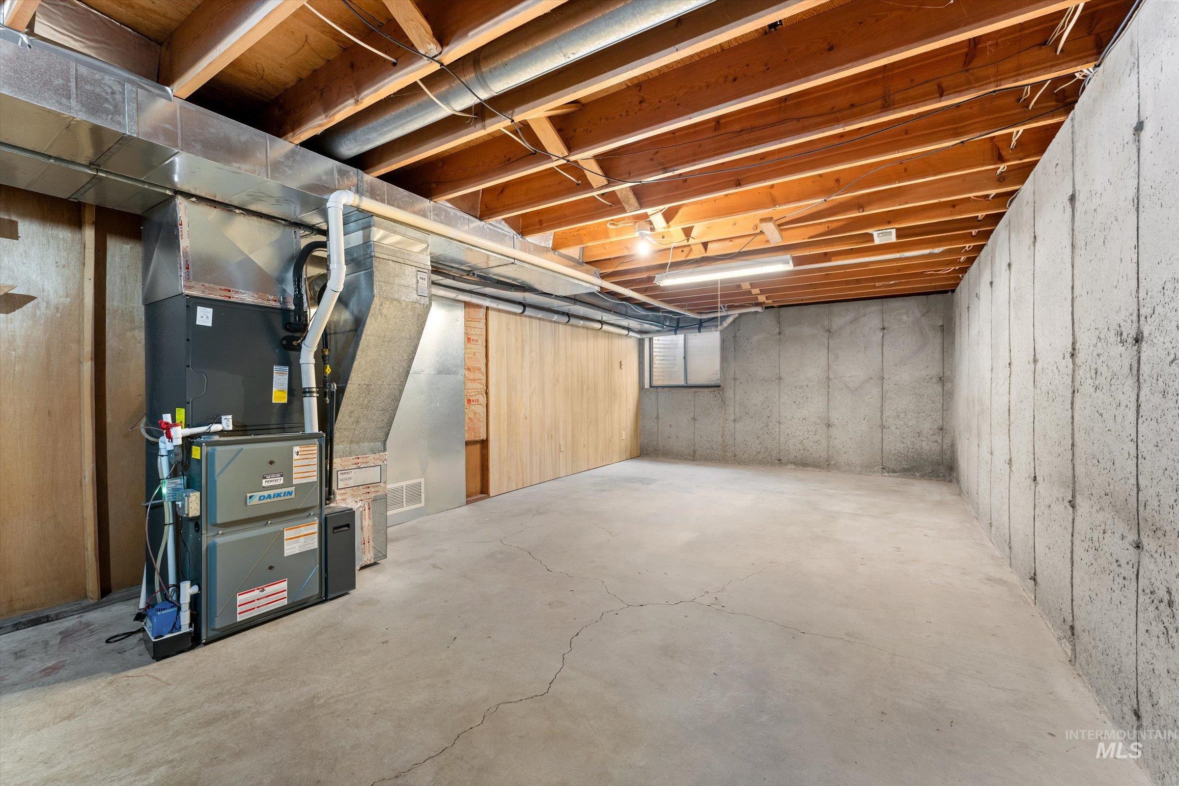 Unfinished below grade area with heating unit