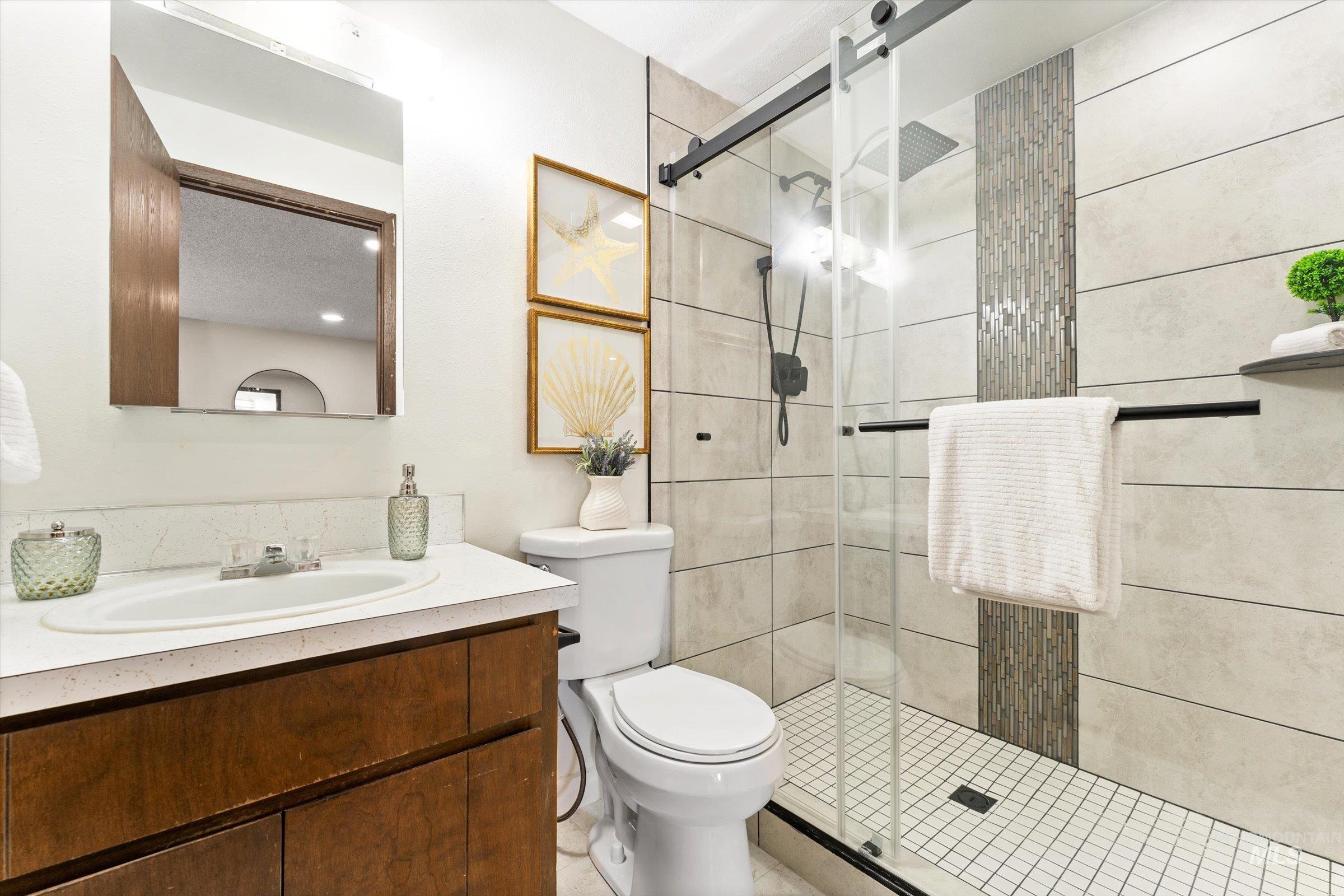 Bathroom featuring vanity and a stall shower