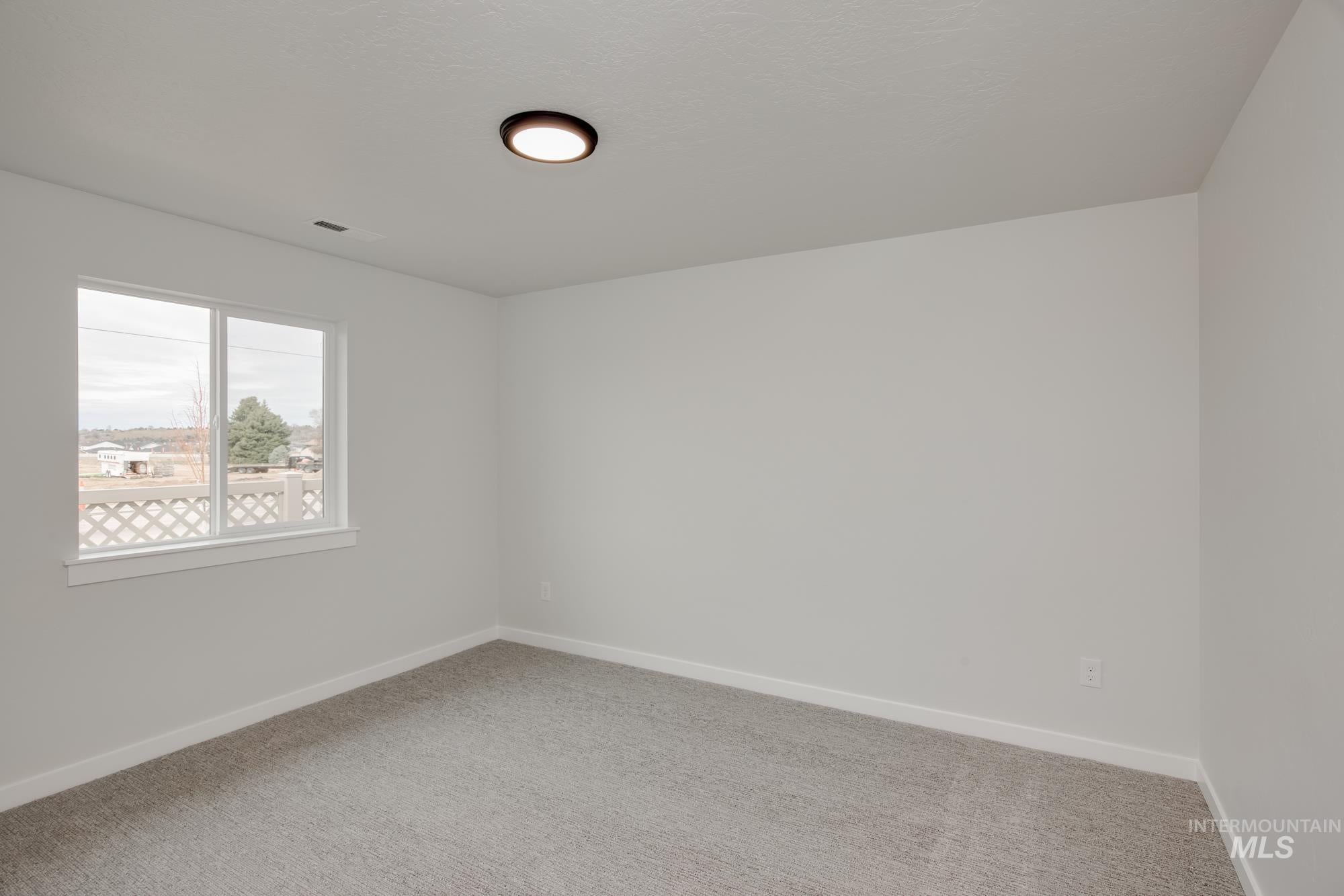 Neutral-toned interior with light grey walls and coordinating carpet flooring