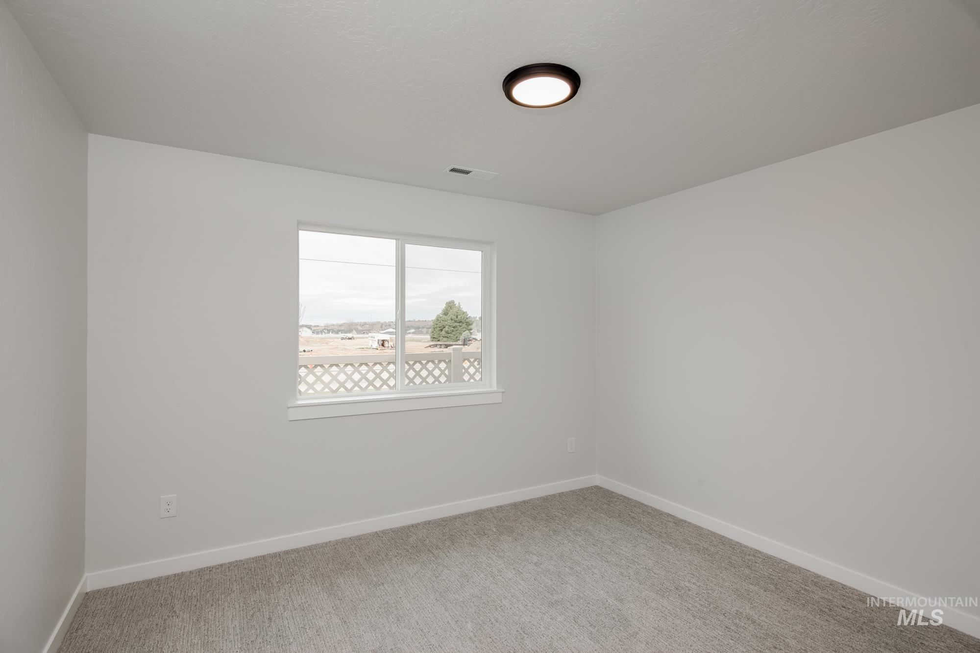 Neutral-toned carpeting paired with white baseboards