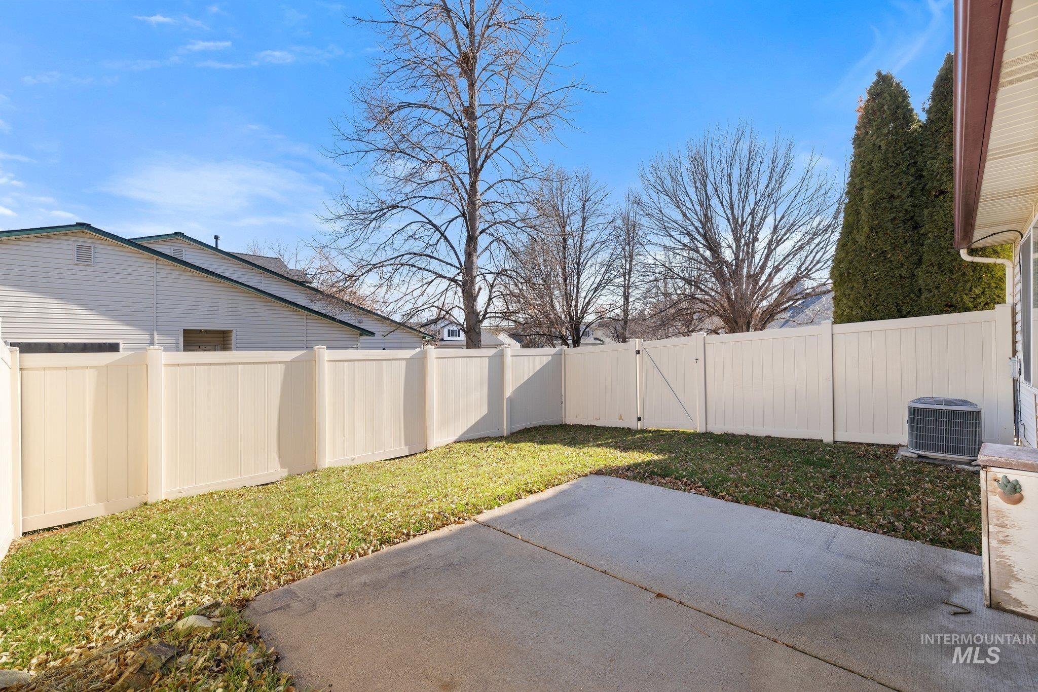 Fenced backyard with a patio area and a gate