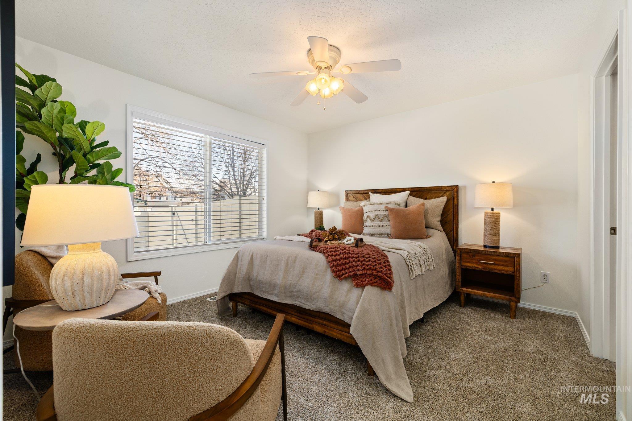 Bedroom featuring a ceiling fan and carpet floors