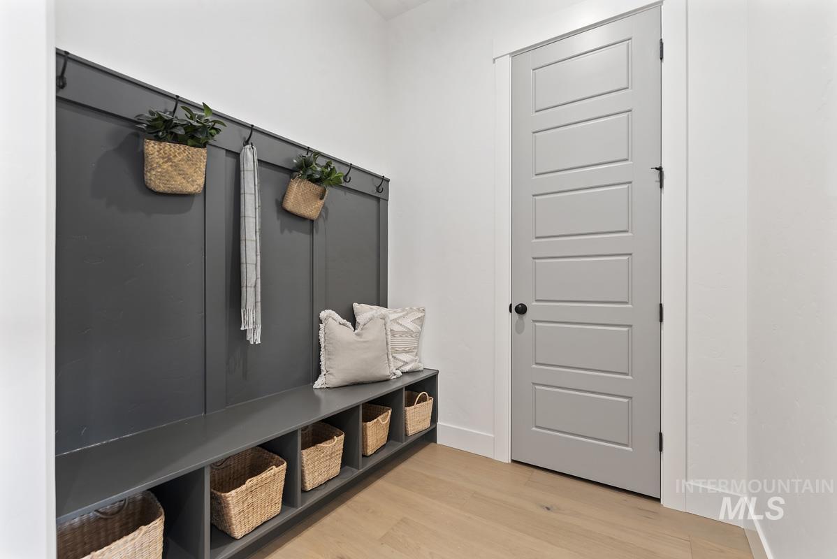 Mudroom featuring baseboards and light wood finished floors