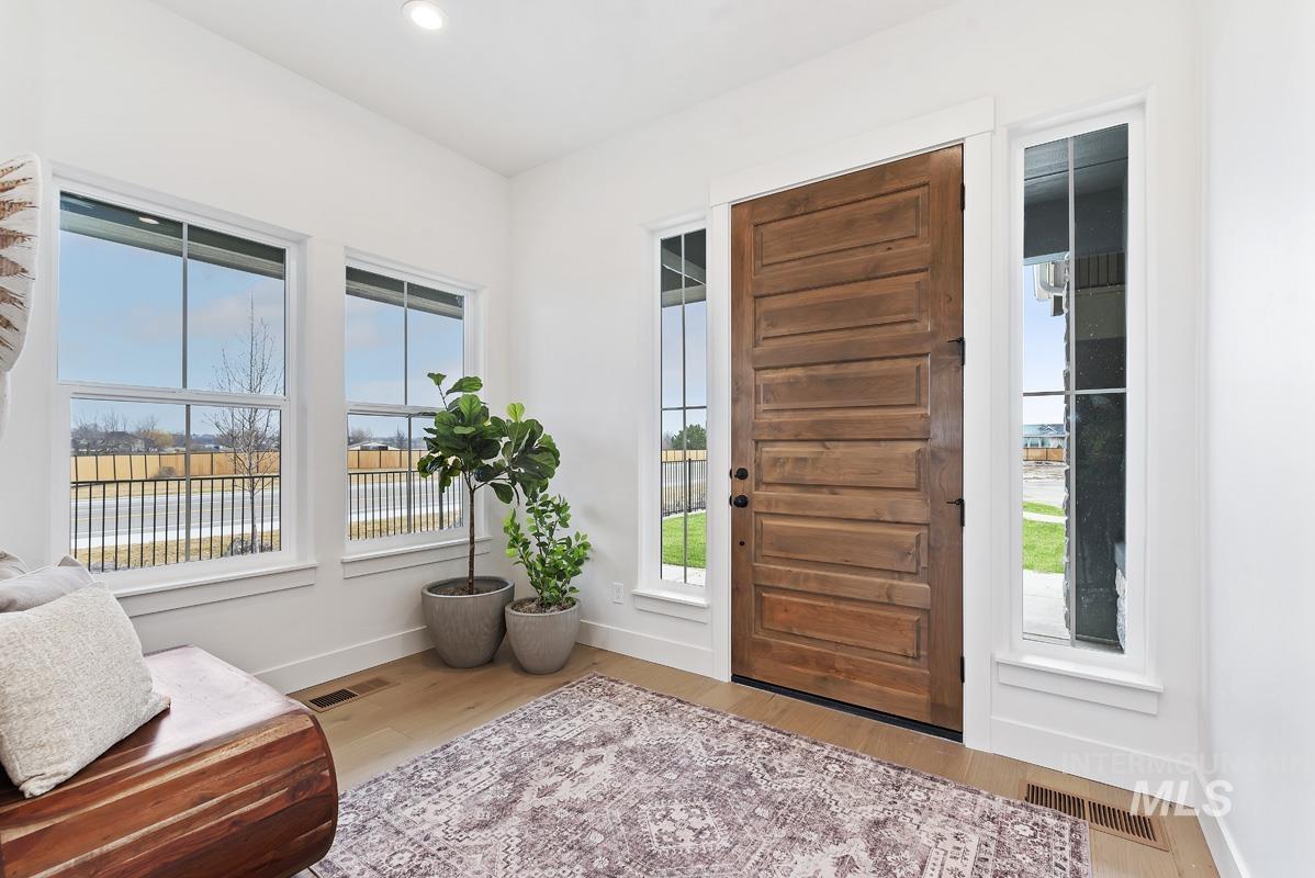 Entryway with plenty of natural light, light wood-style flooring, and recessed lighting