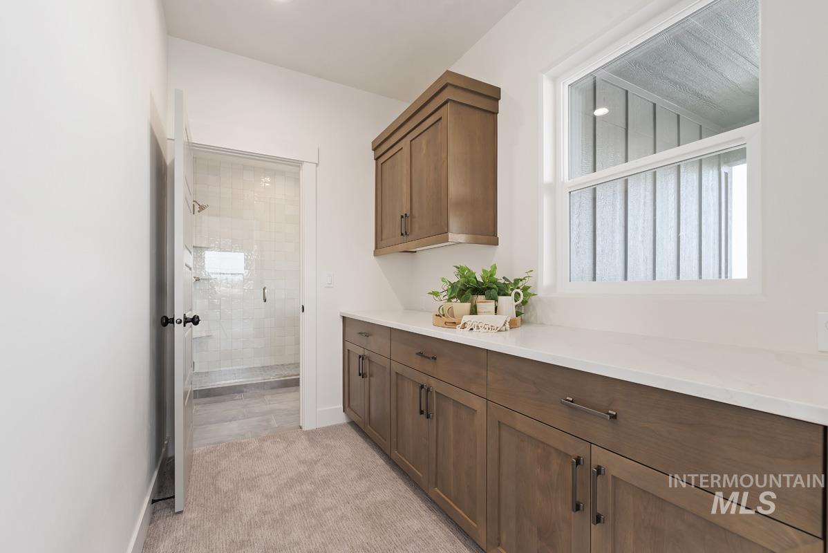 Corridor with baseboards and light colored carpet