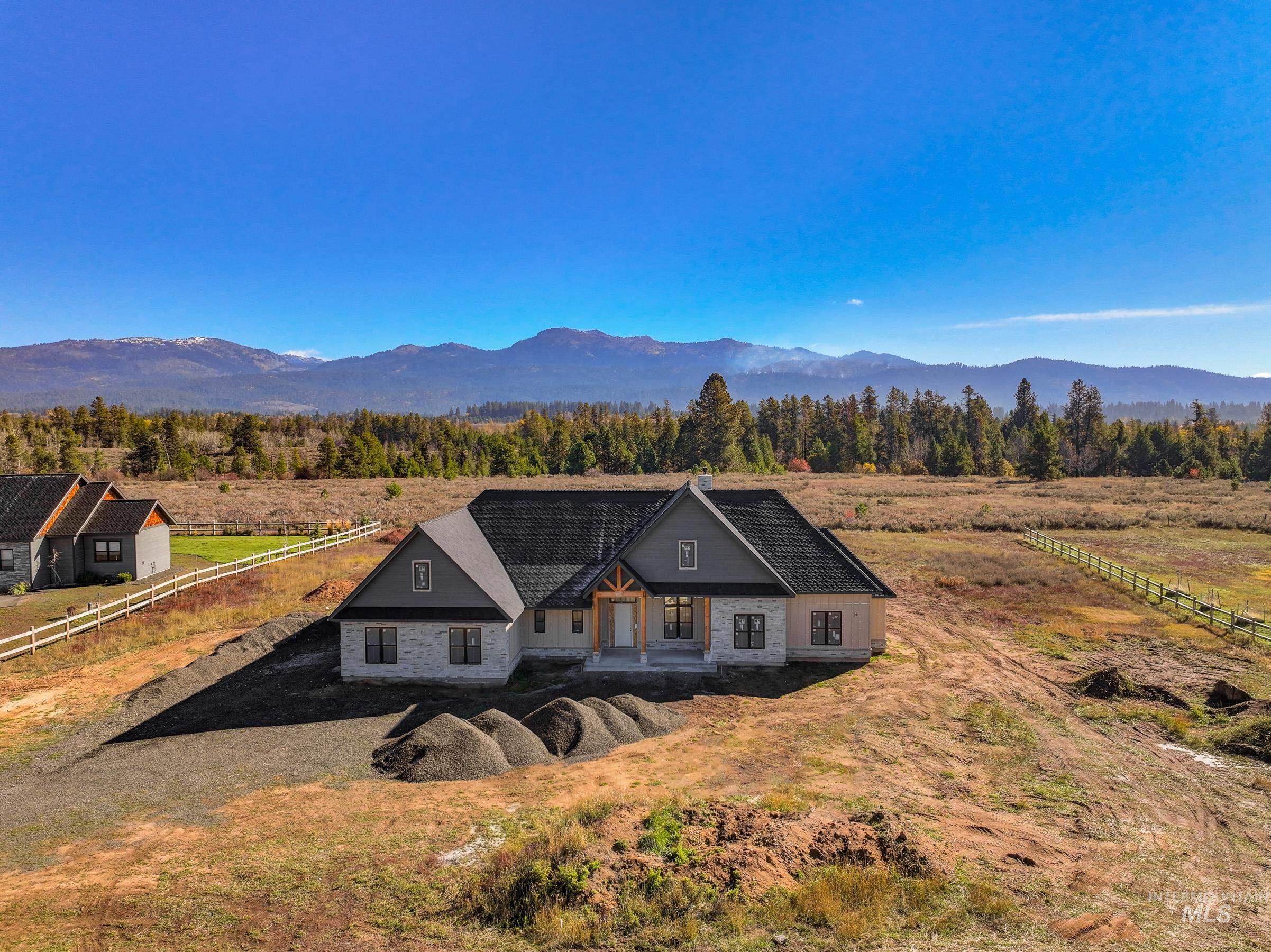 View of front of house with a porch, a mountain view, and a view of countryside