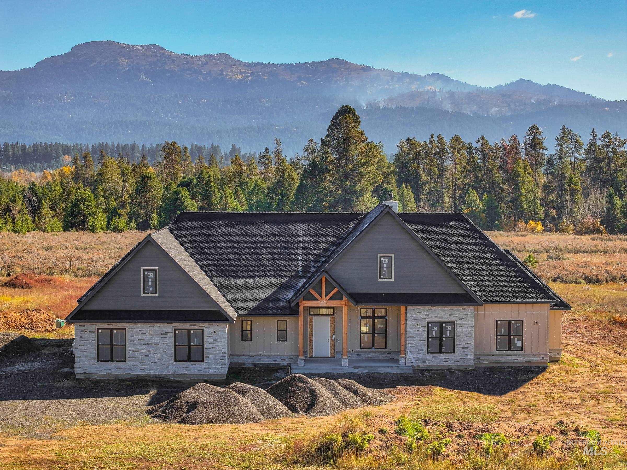 View of front of property featuring a porch, a mountain view, and a forest view