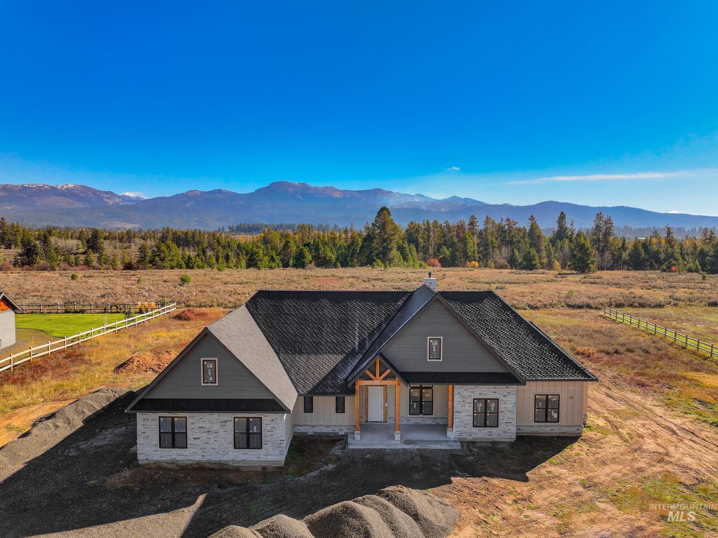 Modern farmhouse style home featuring a view of rural / pastoral area, a mountain view, and a porch