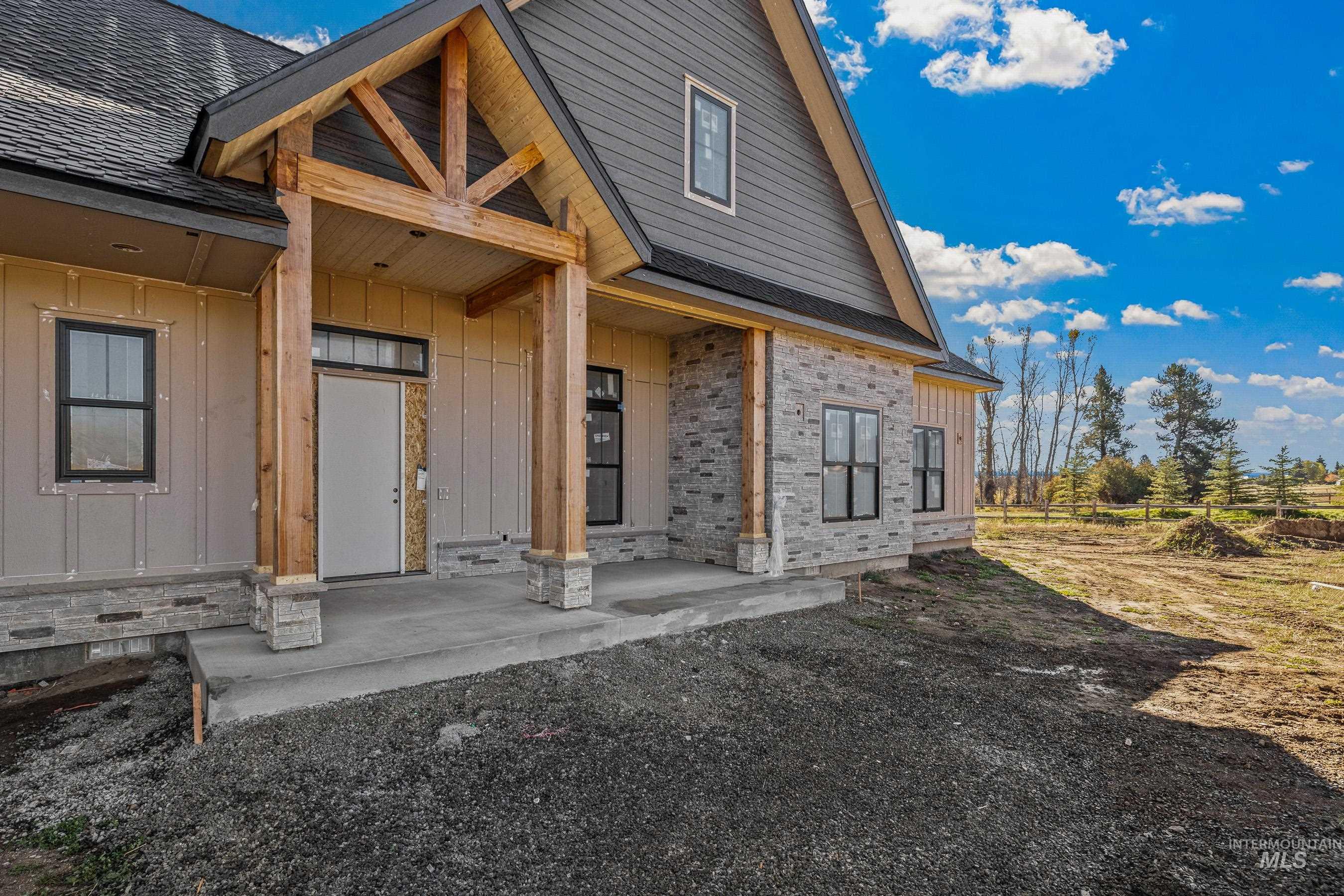 Property entrance with covered porch and board and batten siding