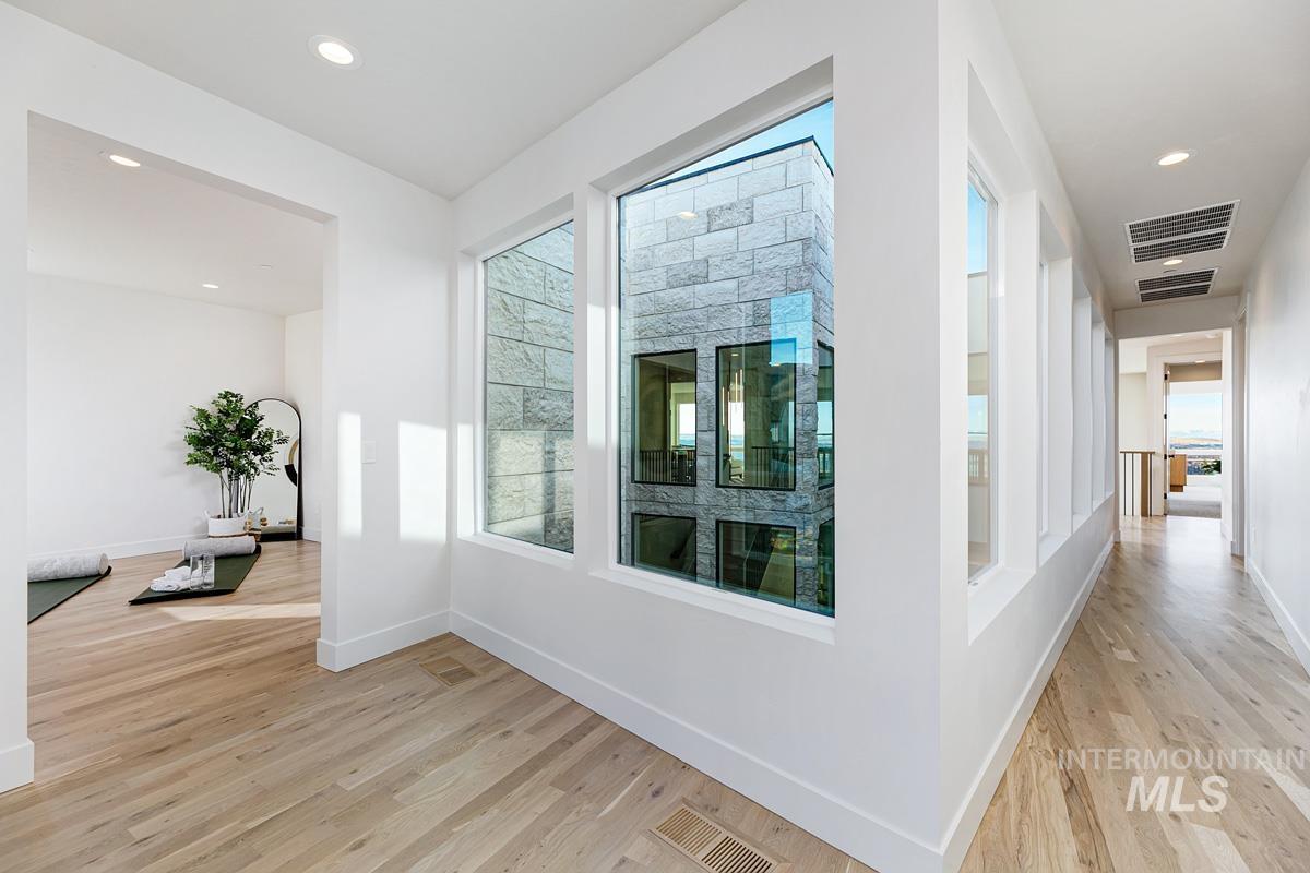Hall with recessed lighting and light wood-style flooring