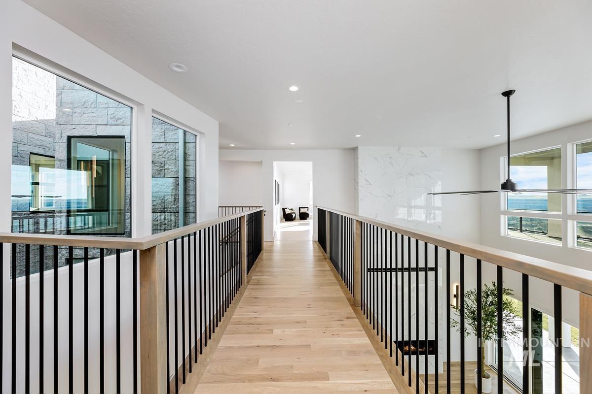 Corridor featuring healthy amount of natural light, light wood-style flooring, and recessed lighting