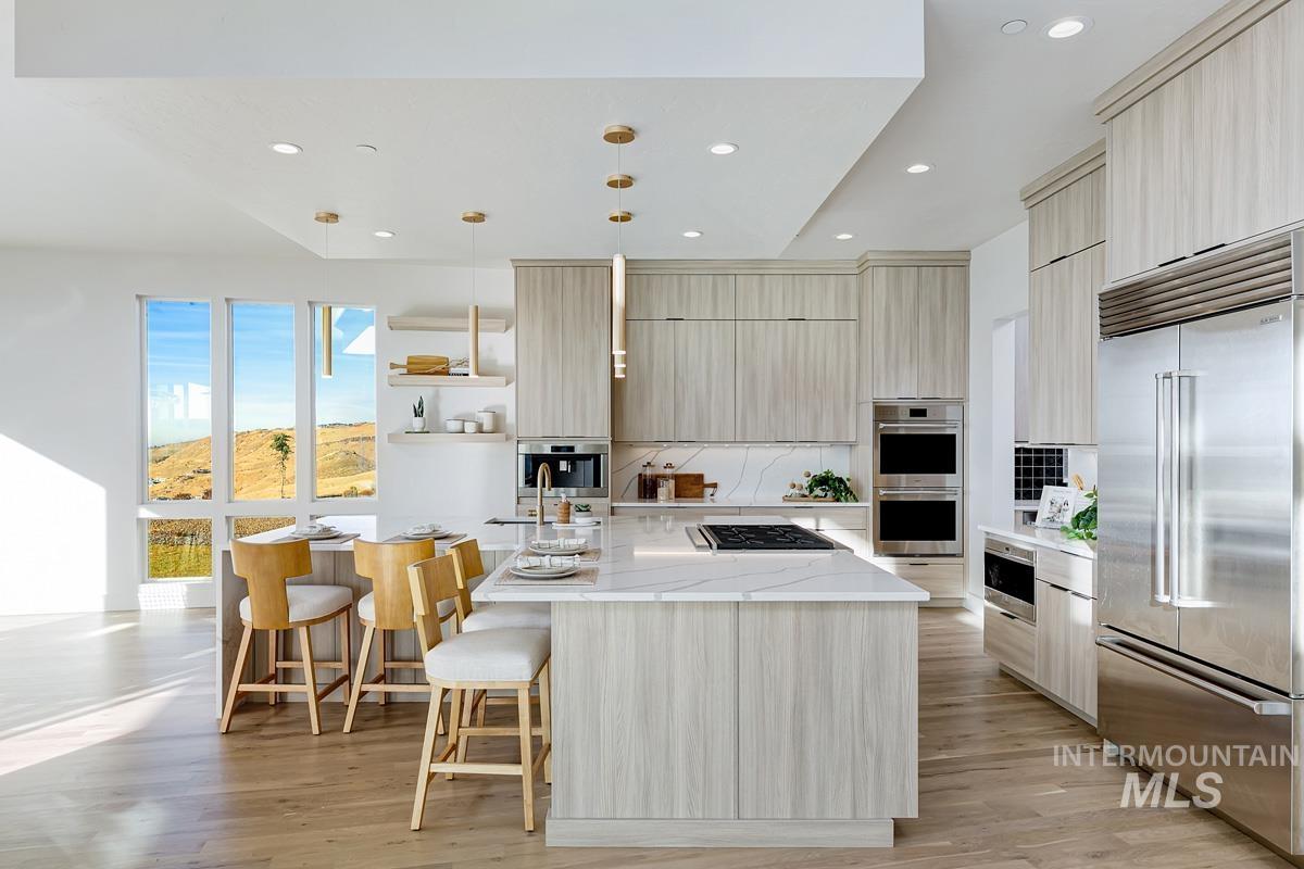 Kitchen with open shelves, light stone countertops, appliances with stainless steel finishes, an island with sink, and recessed lighting