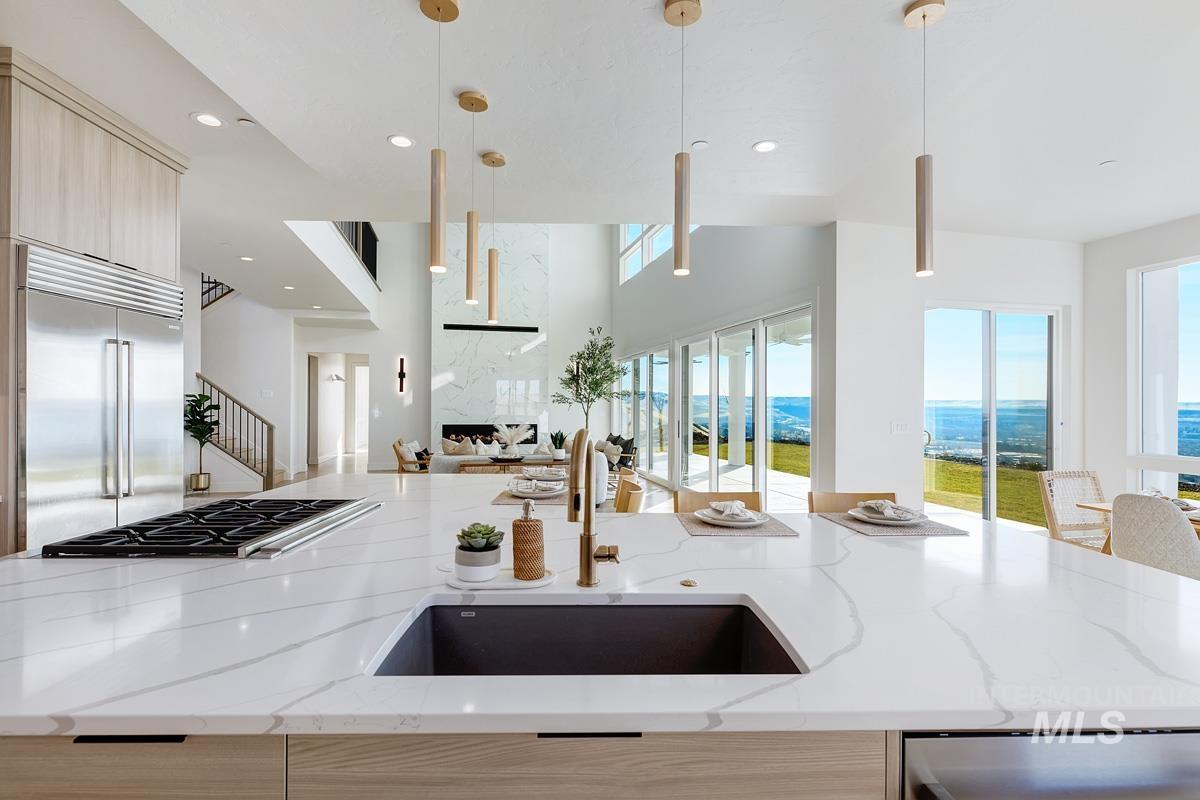 Kitchen featuring light brown cabinetry, light stone countertops, modern cabinets, and recessed lighting