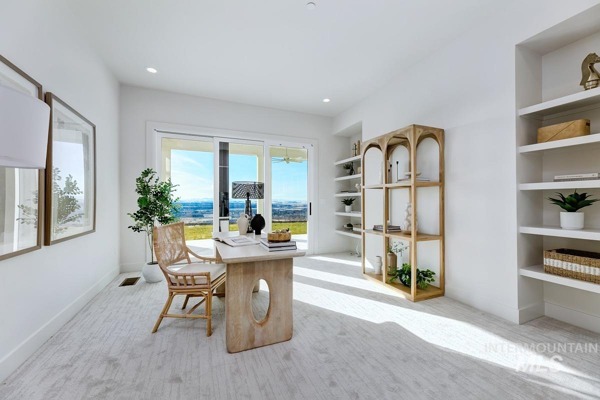 Office area with light colored carpet, built in shelves, and recessed lighting