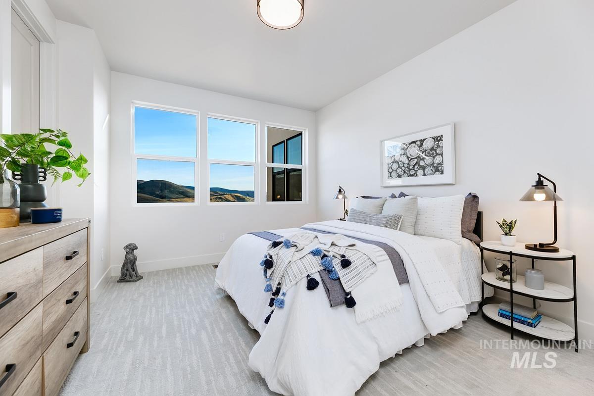 Bedroom with baseboards and a mountain view