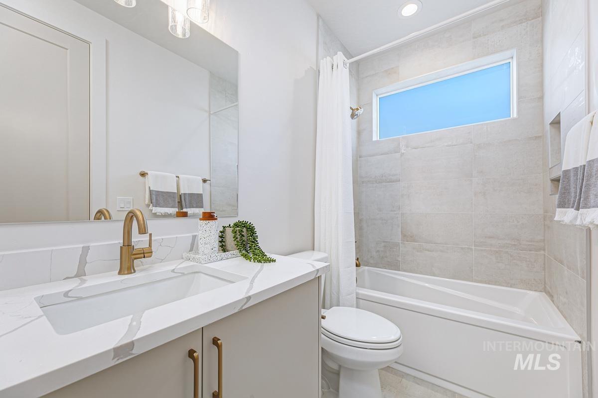 Full bath featuring shower / bath combo, vanity, and recessed lighting