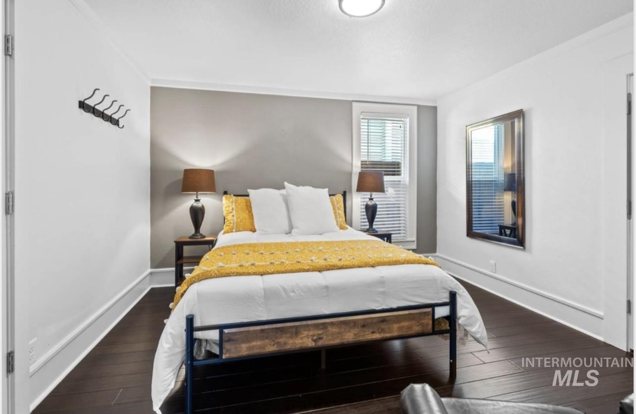 Bedroom featuring dark wood-style floors