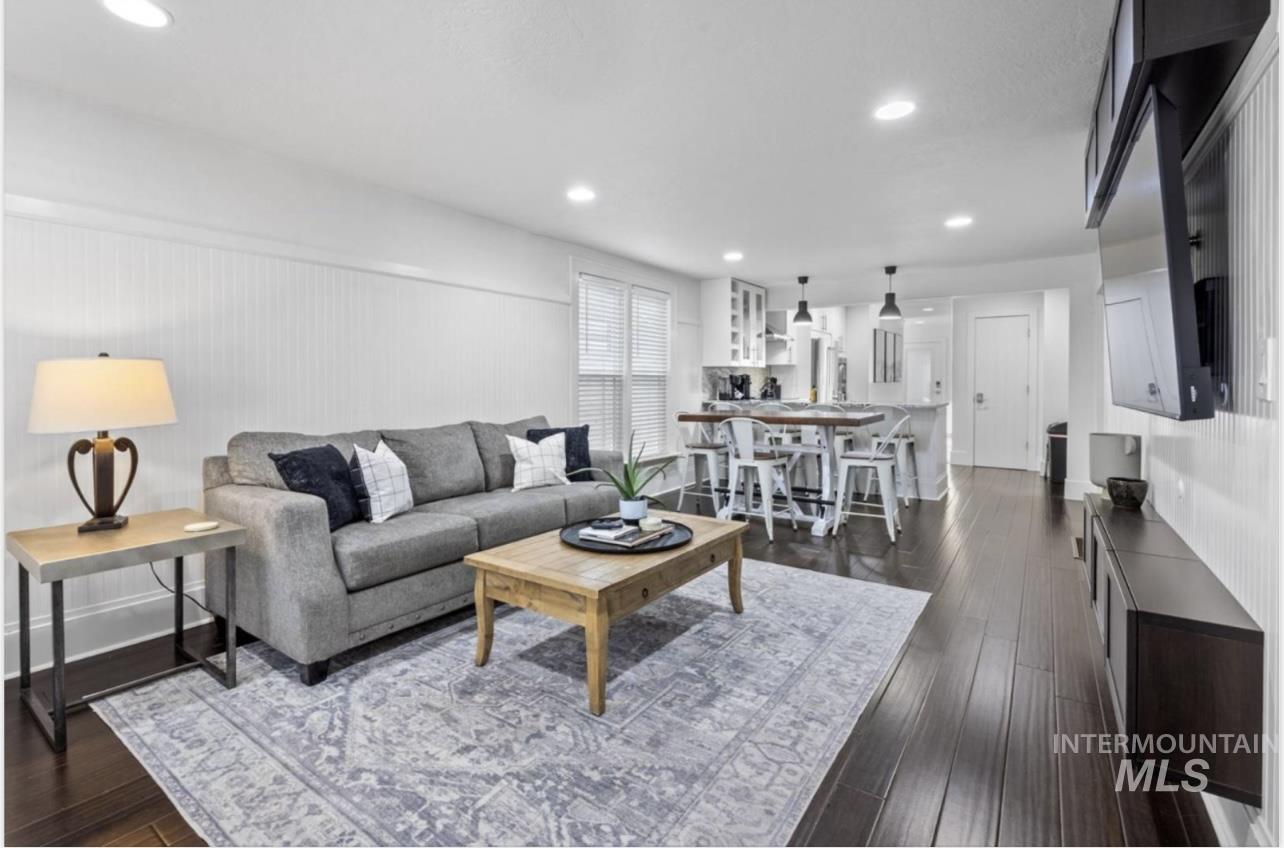 Living room featuring recessed lighting and dark wood-type flooring