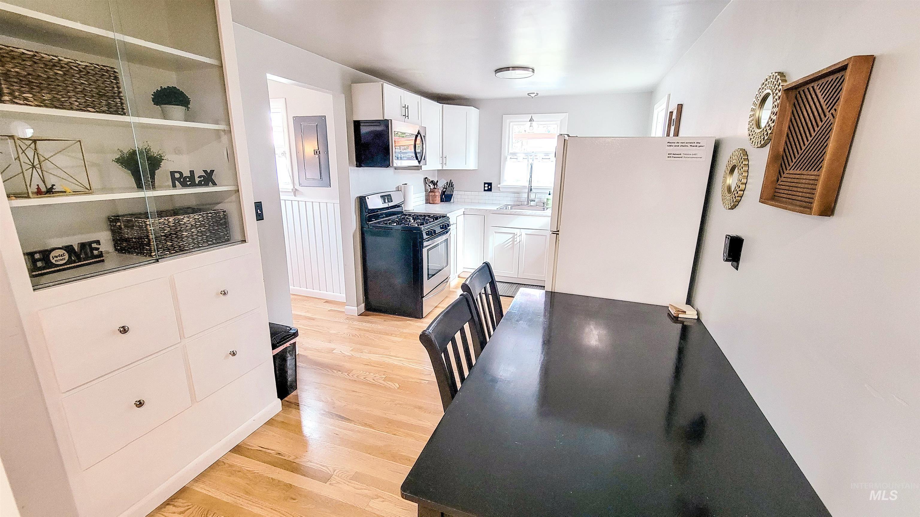 Kitchen and dining area featuring light wood-finish flooring