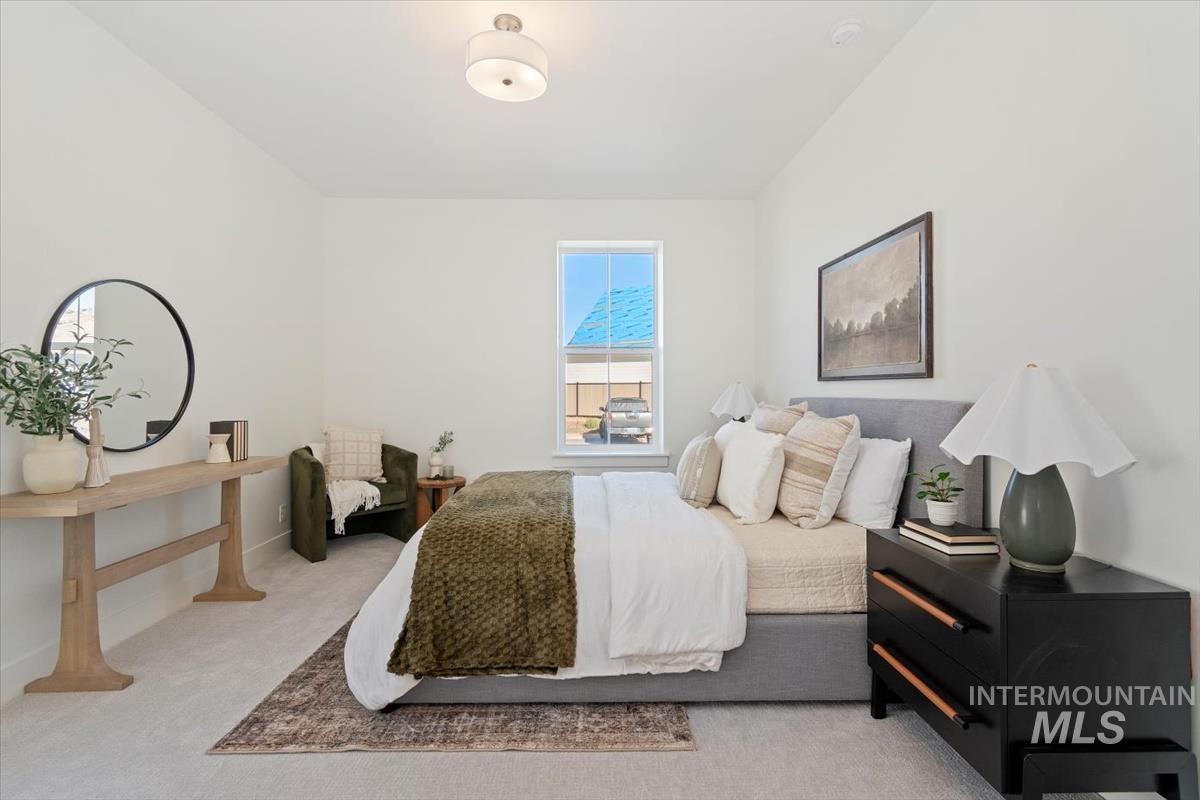 Carpeted bedroom featuring baseboards