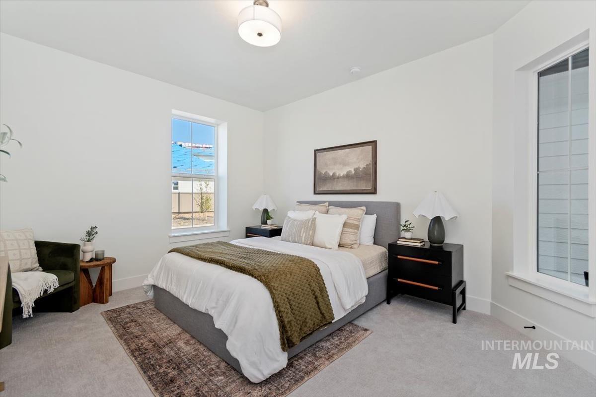 Bedroom featuring light carpet