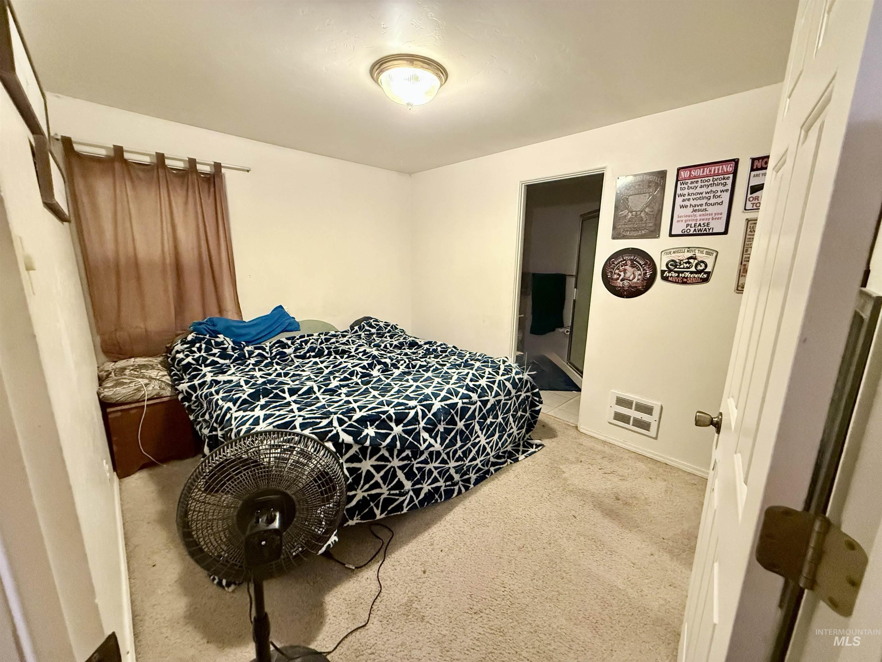 Carpeted bedroom featuring baseboards