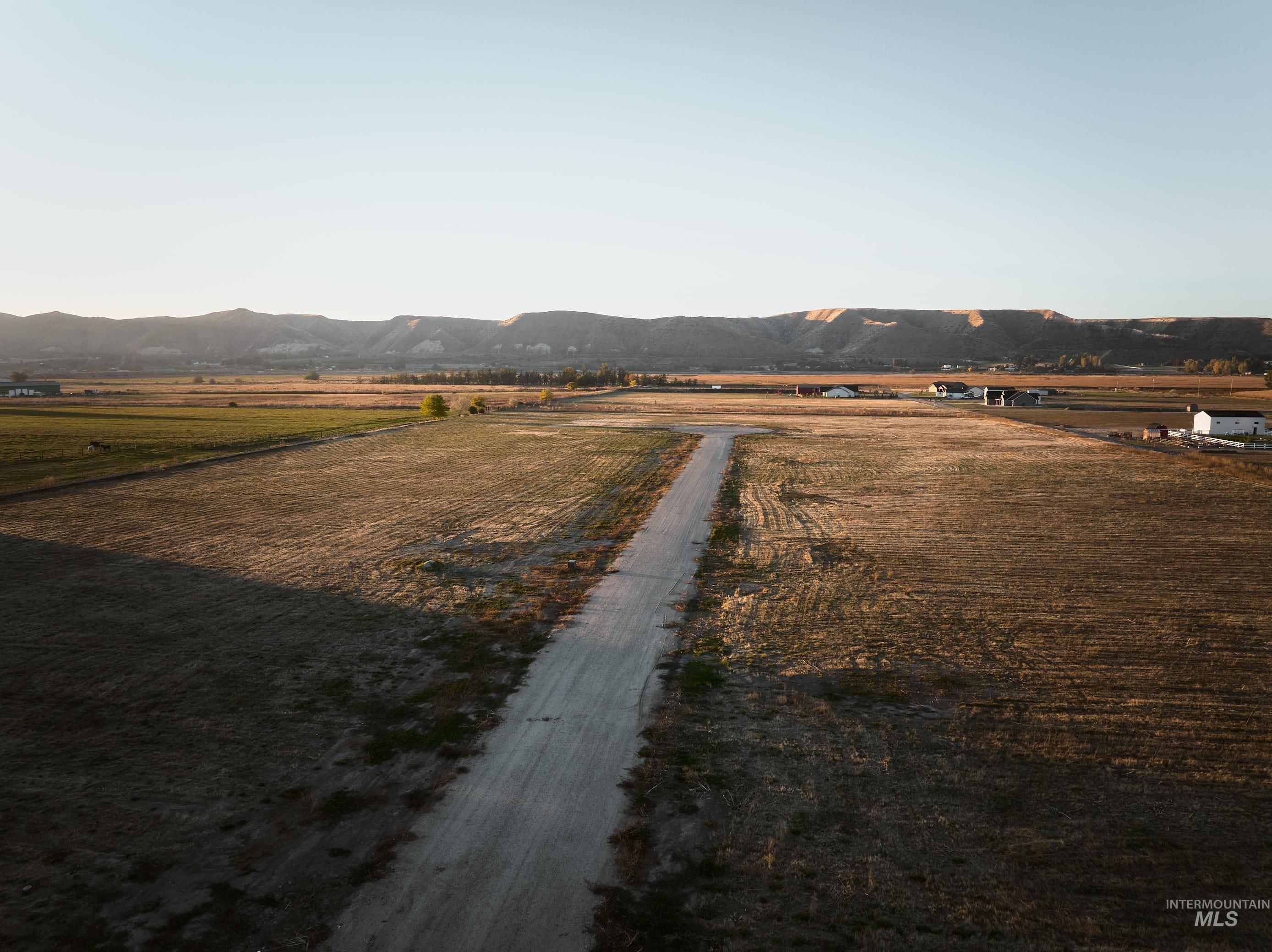 View of street with a view of countryside, agricultural area, and a mountain view