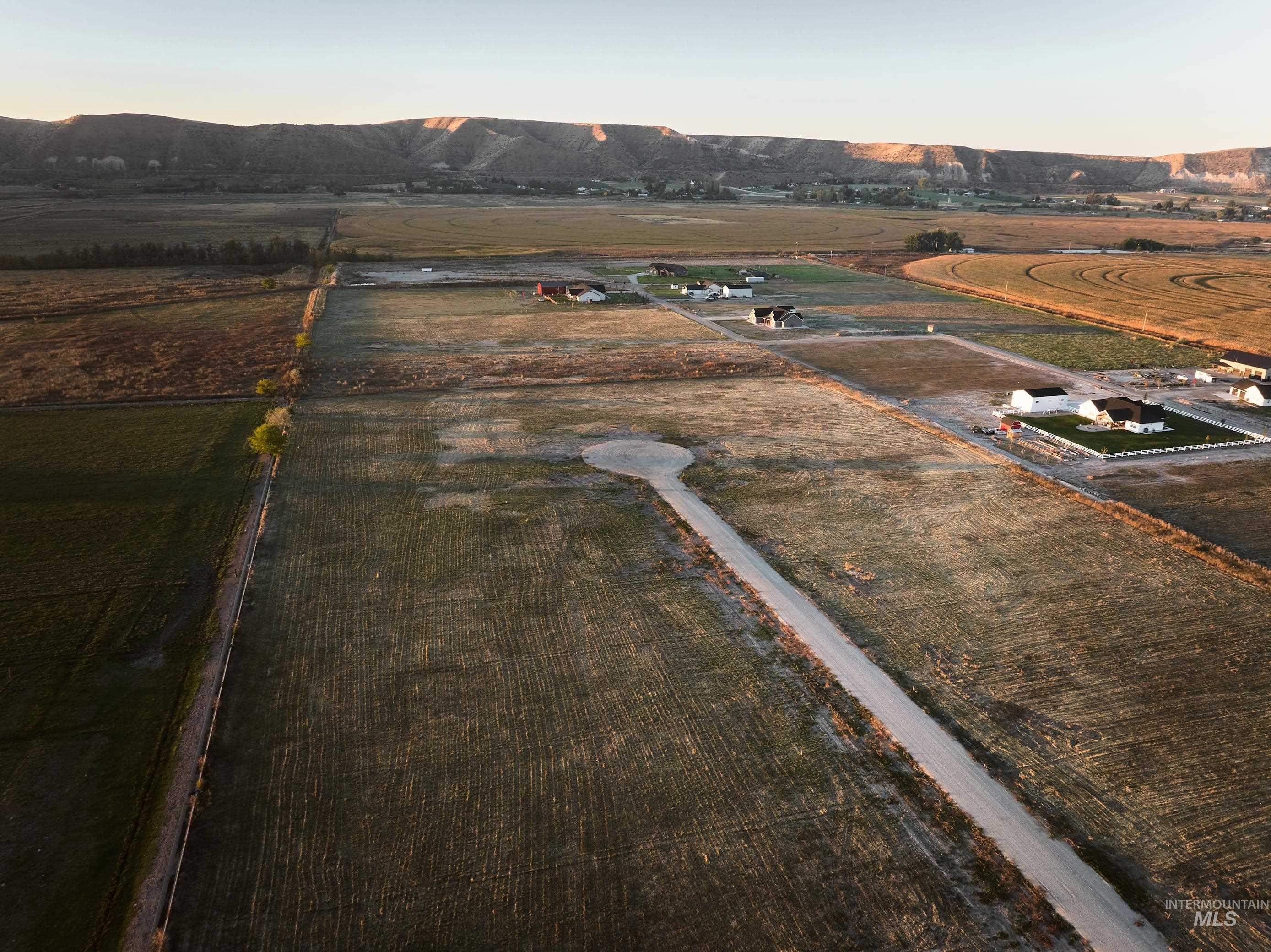 View of property location featuring rural landscape, a mountainous background, and large plots for crops