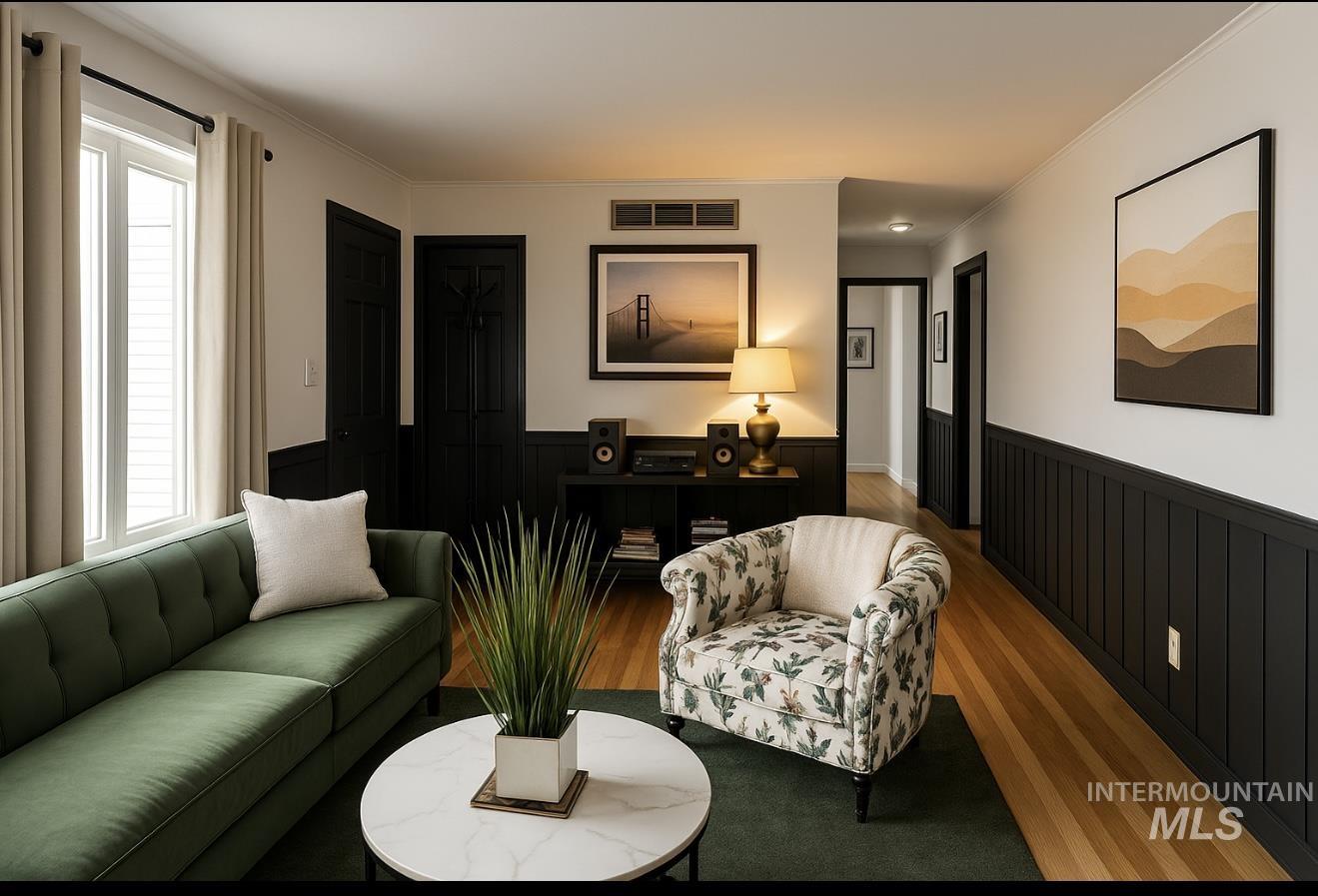 Living room with wainscoting, healthy amount of natural light, wood finished floors, and ornamental molding