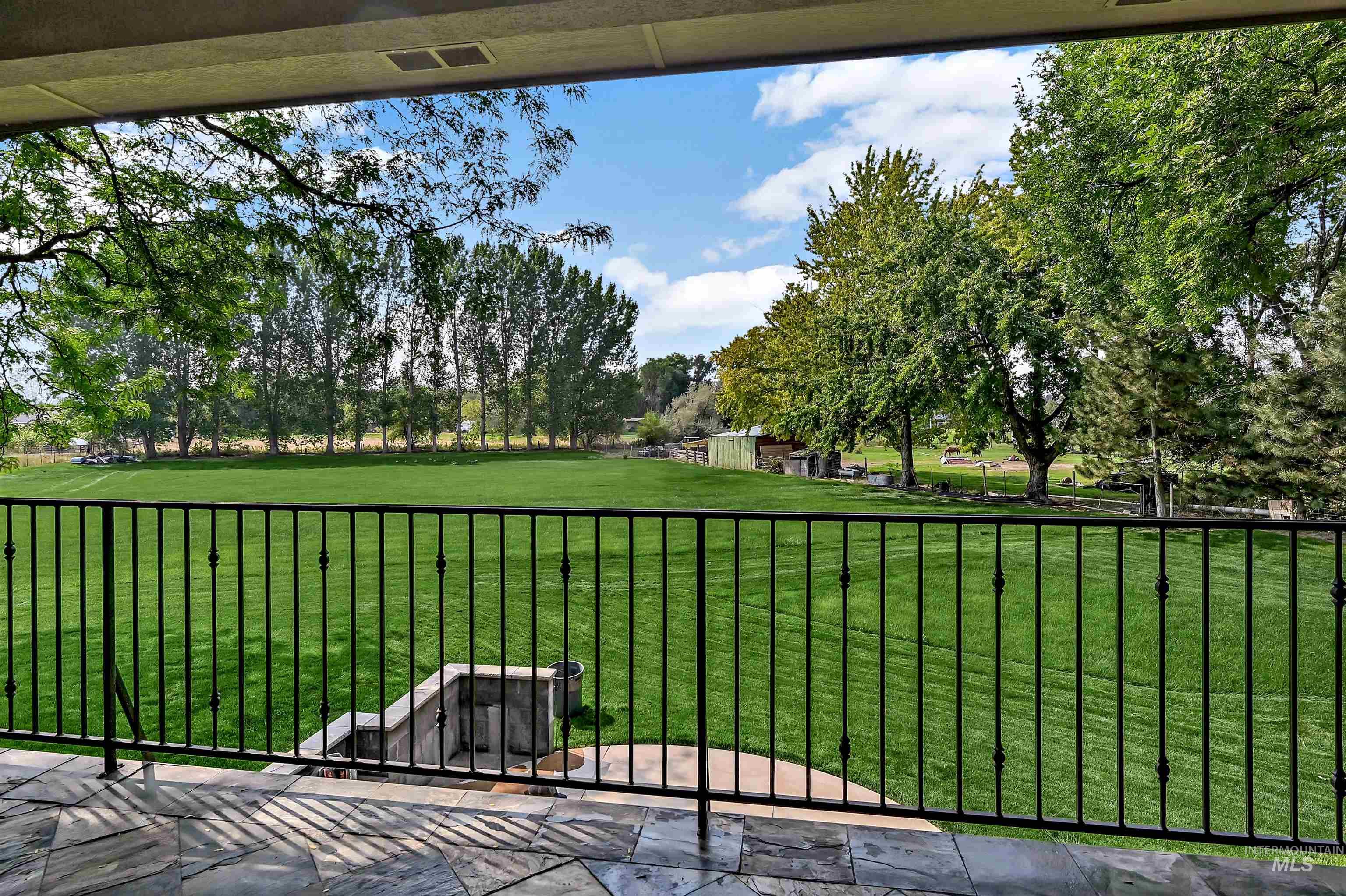 View of yard with a balcony