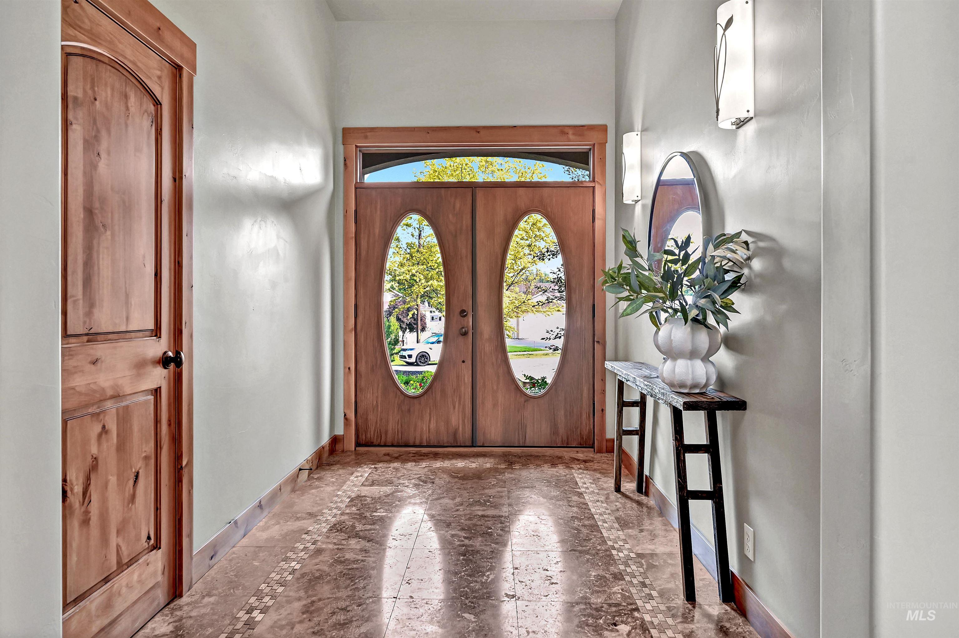 Entryway with baseboards and french doors