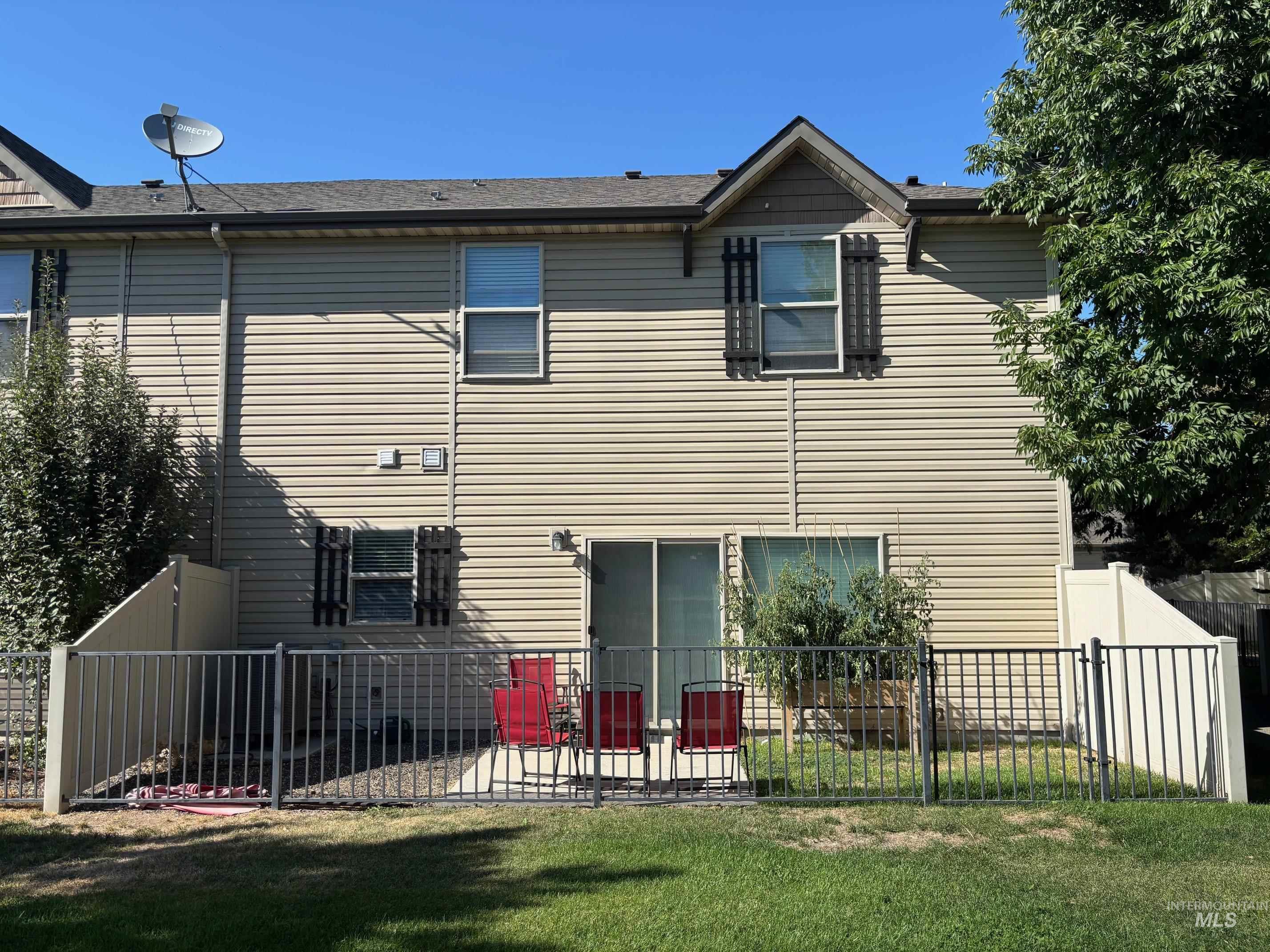 Back of property with a fenced backyard and a patio