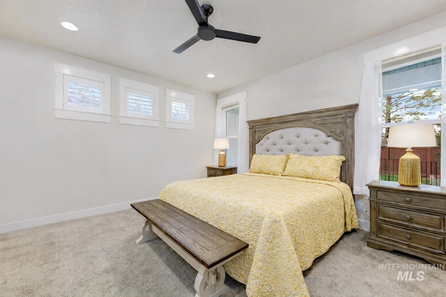 Bedroom with light colored carpet, a ceiling fan, and recessed lighting