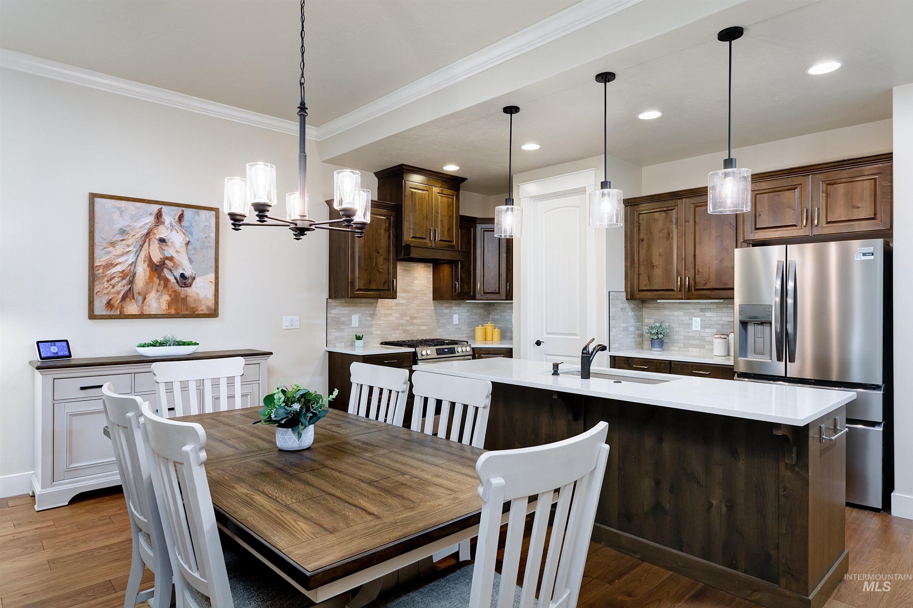 Dining area featuring crown molding, dark wood finished floors, a chandelier, and recessed lighting