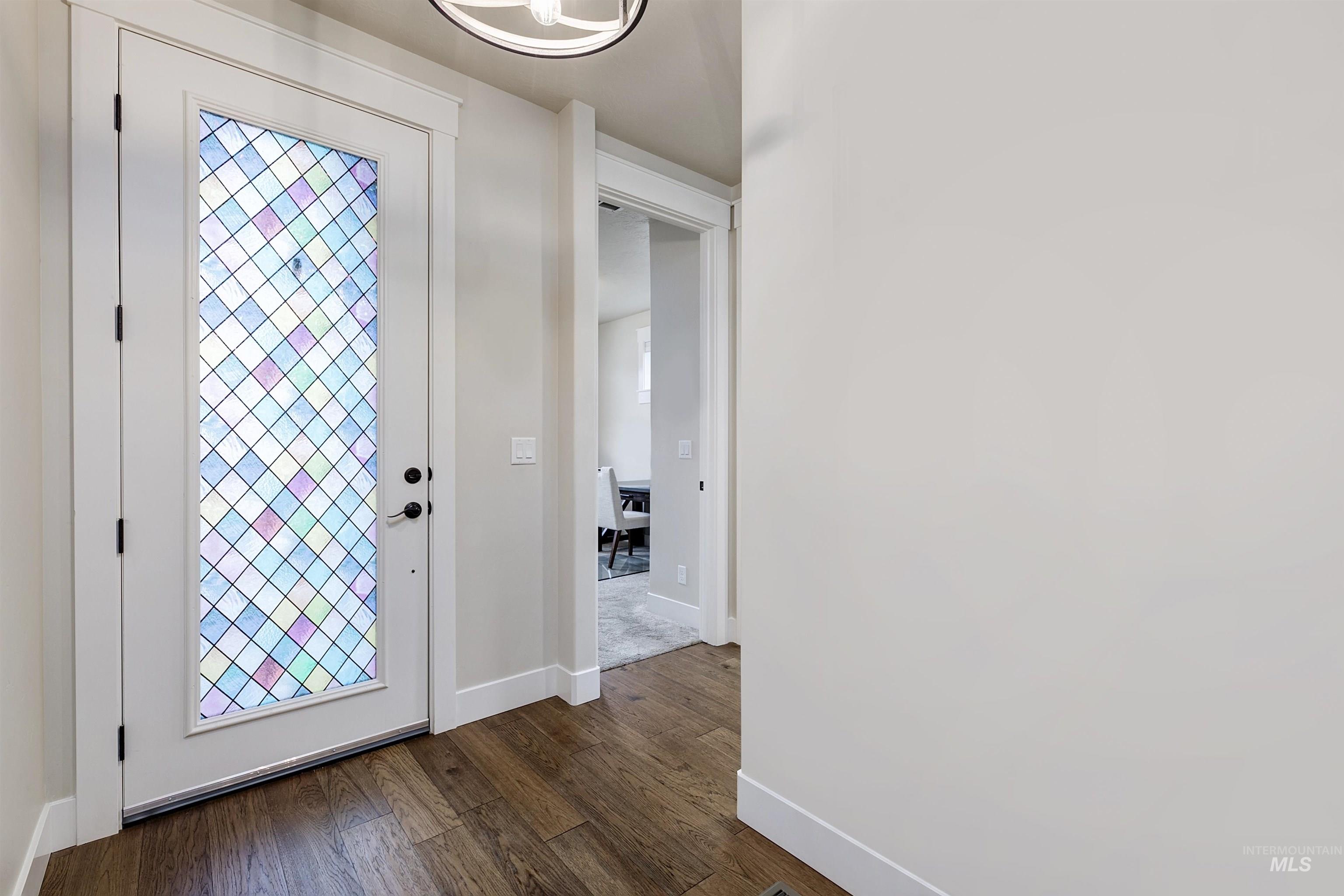 Foyer entrance with baseboards and dark wood finished floors