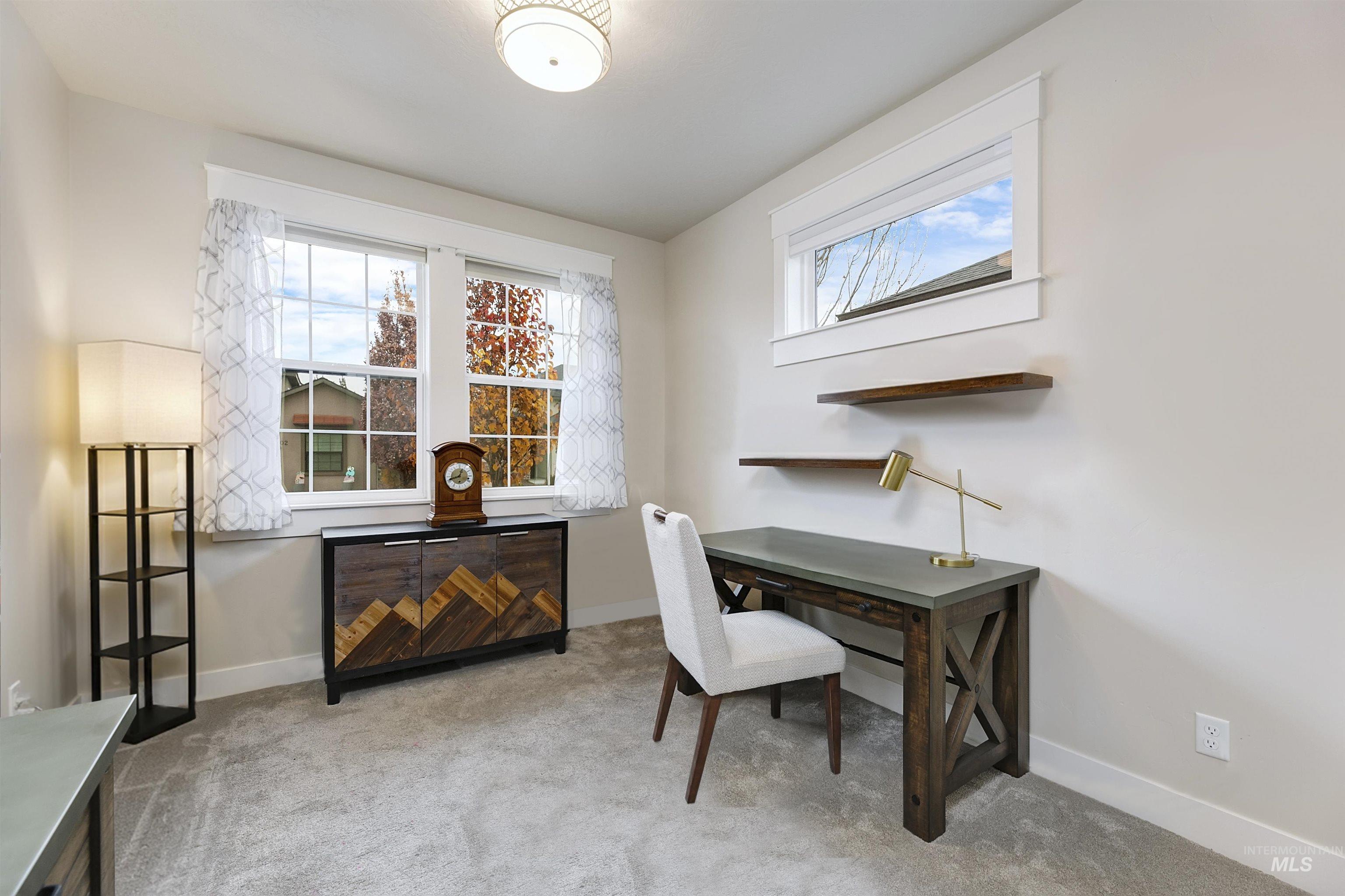 Kitchen is designed for both style and function, featuring a generous center island, custom cabinetry, quartz countertops, stainless steel appliances, and a spacious walk-in pantry.