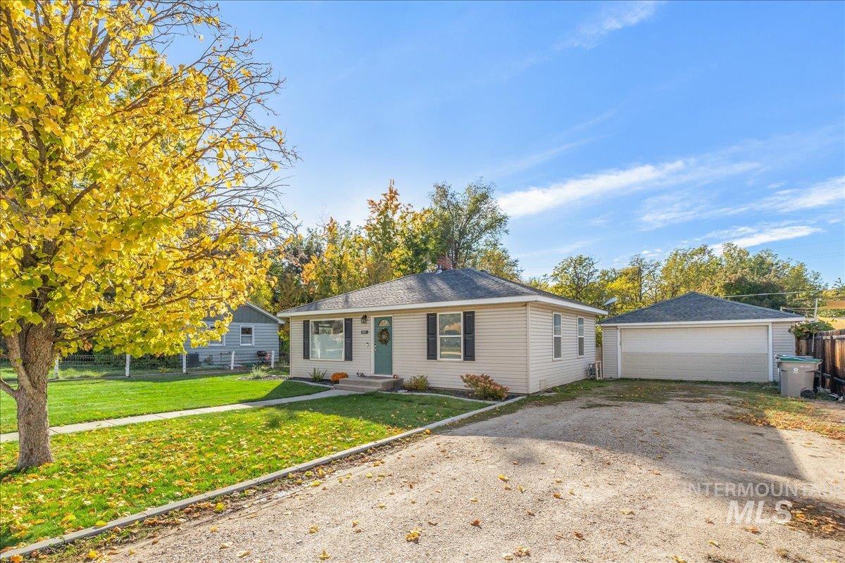Ranch-style home with an outdoor structure and a garage