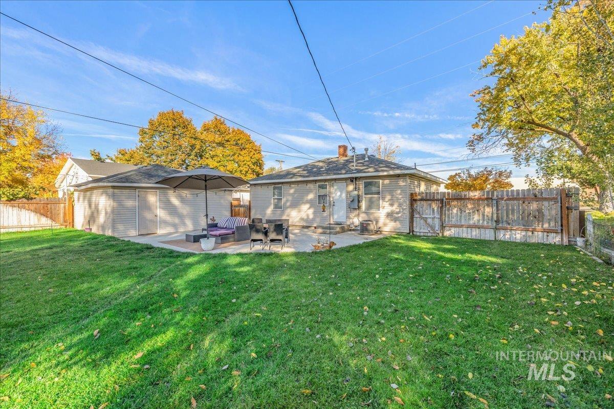 Rear view of house with a patio, a fenced backyard, and a chimney