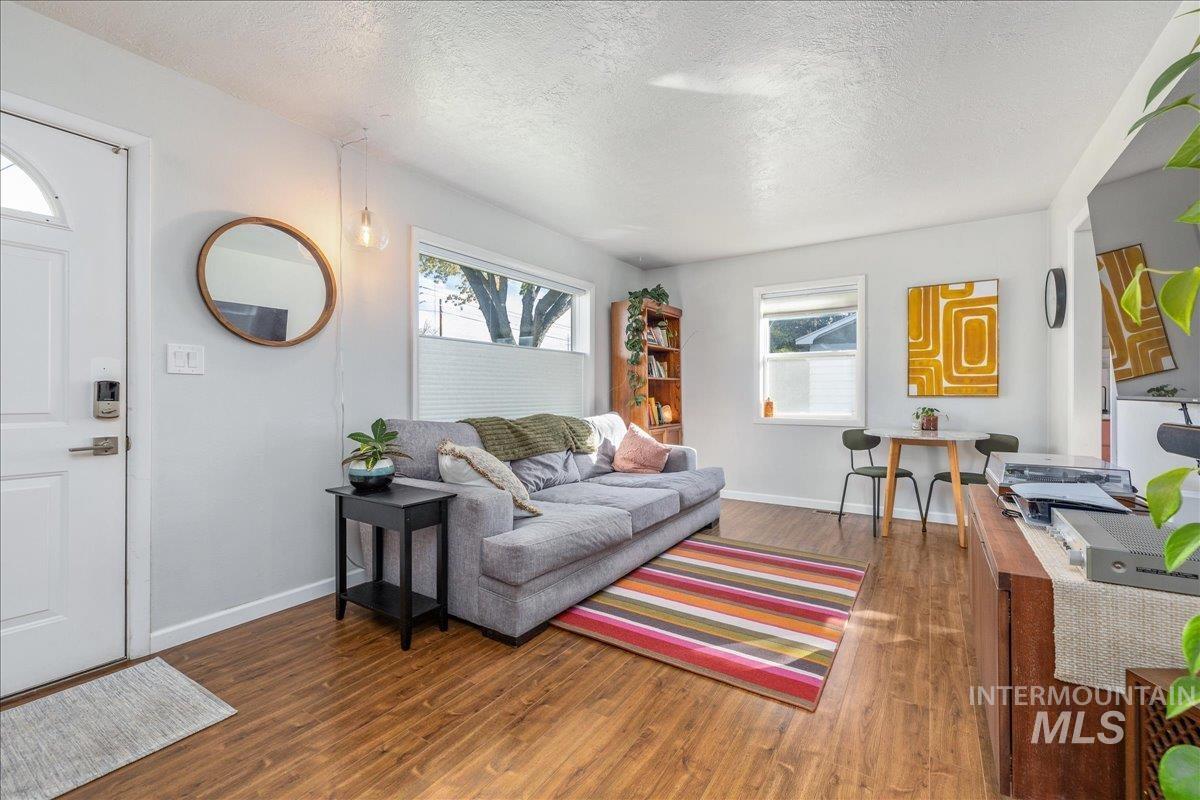 Living room featuring a textured ceiling and wood finished floors