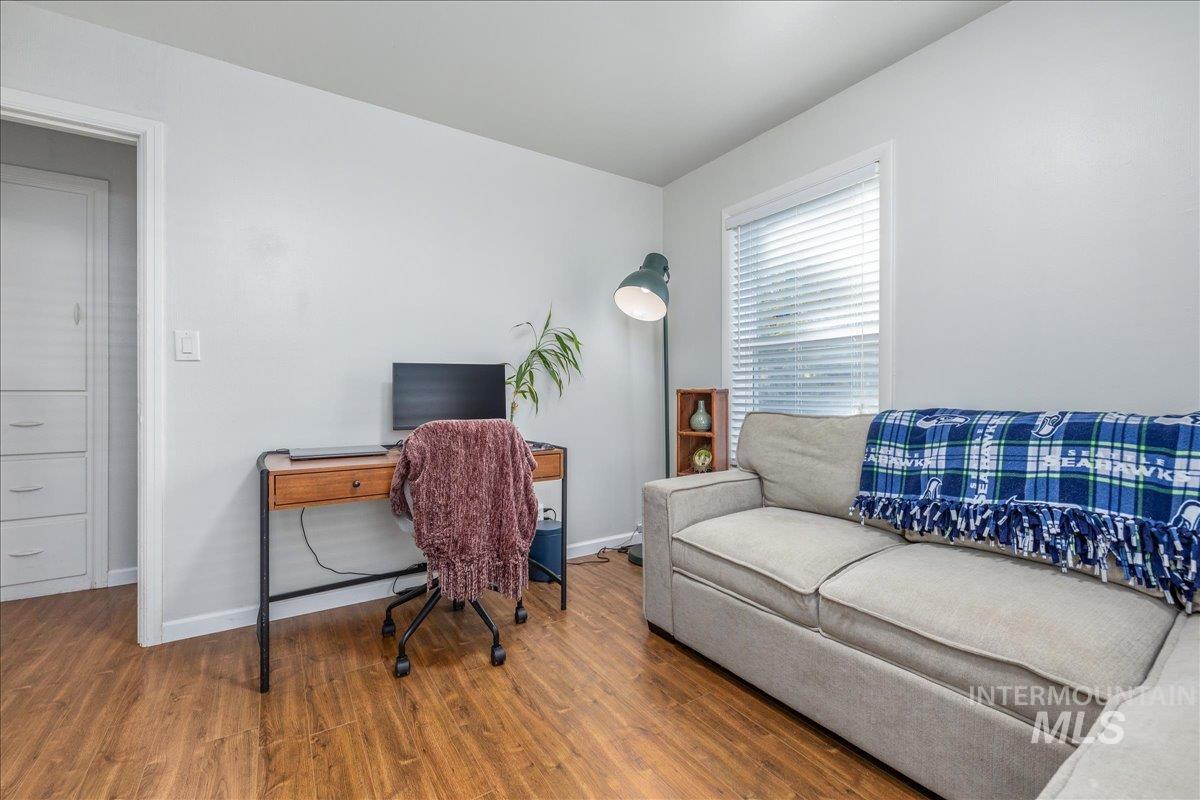 Home office featuring wood finished floors and baseboards