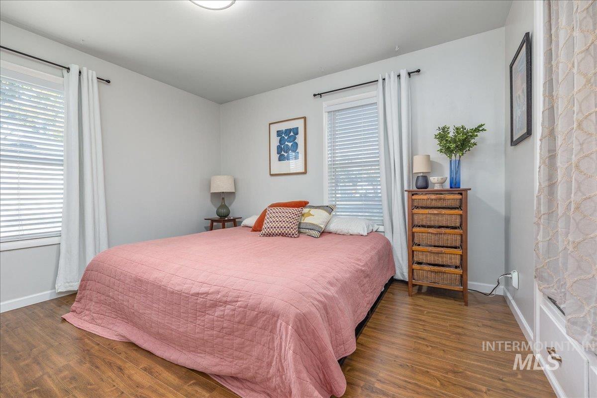 Bedroom with wood finished floors and baseboards