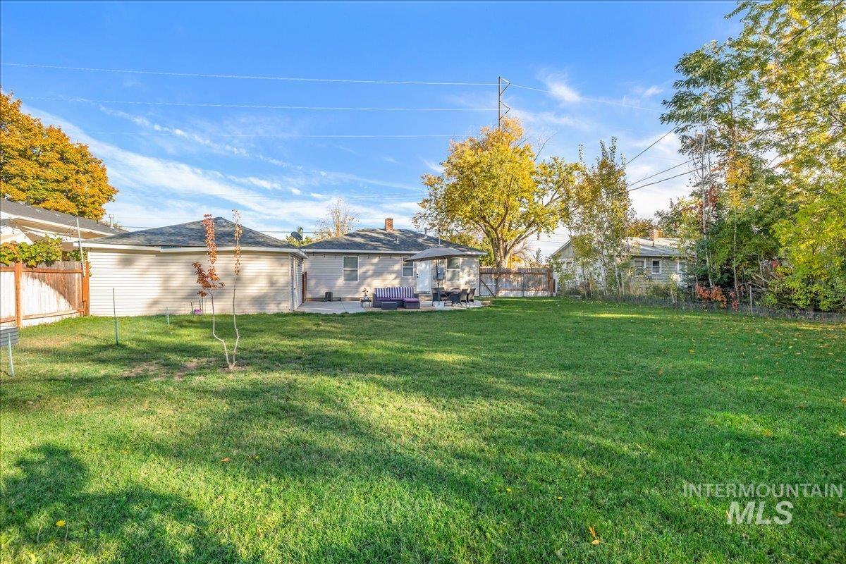 Fenced backyard featuring a patio and outdoor lounge area