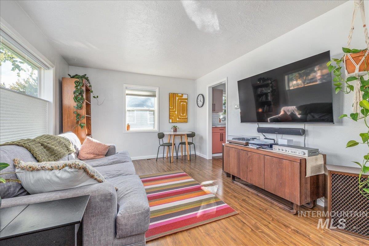 Living area featuring wood finished floors and a textured ceiling