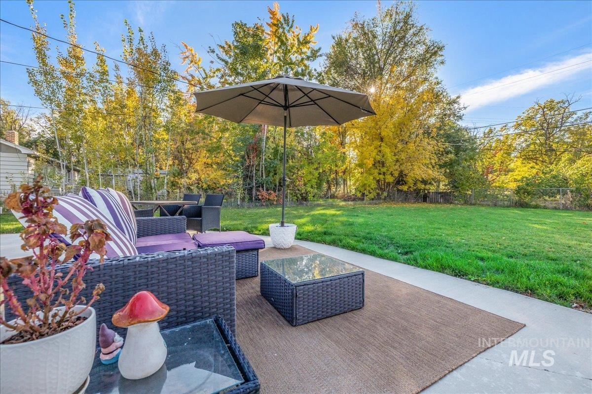 Fenced backyard featuring an outdoor living space and a patio