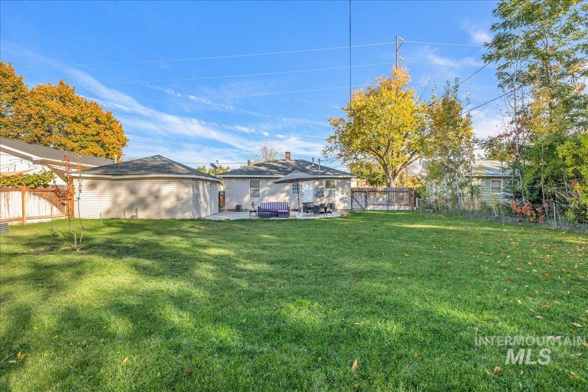 Fenced backyard with a patio