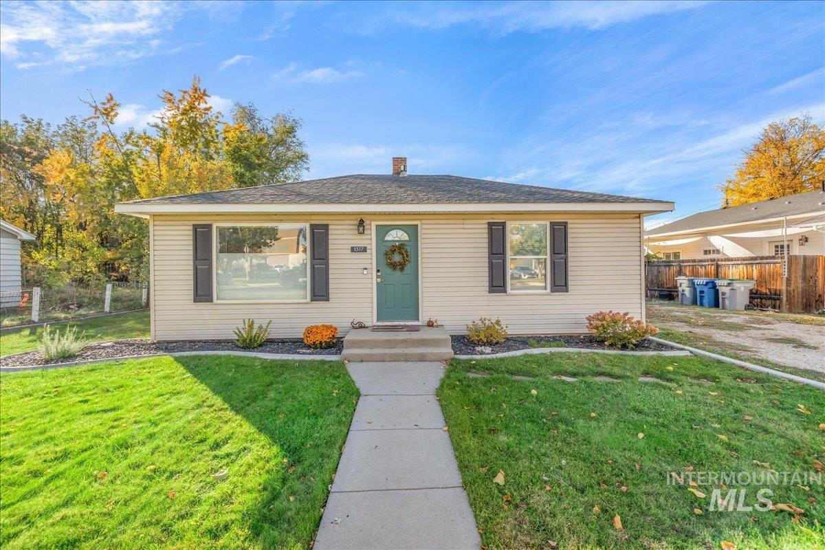 View of front of house with a chimney and roof with shingles