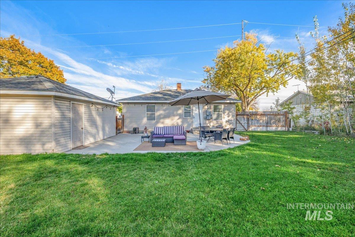Rear view of house featuring a patio, outdoor lounge area, and an outdoor structure